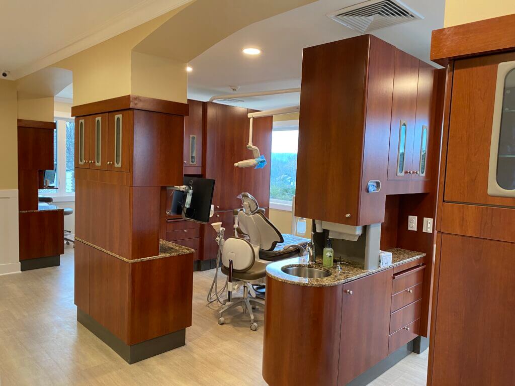 Modern dental office with wood cabinetry.